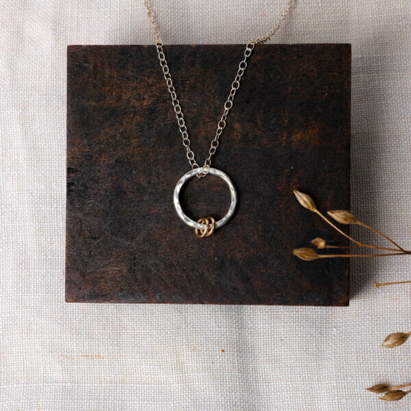 Hammered silver necklace with gold rings