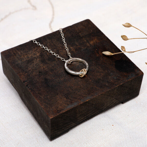 Hammered silver necklace with gold rings