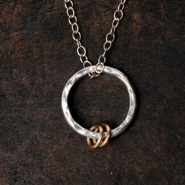 Hammered silver necklace with gold rings